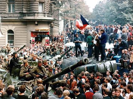 TO GO WITH AFP STORY IN FRENCH BY JAN MARCHAL** Il y a quarante ans, le "Printemps de Prague" étouffé dans le sang** (FILES) File picture of Czech youngsters holding a Czechoslovak flag standing atop an overturned truck as other Prague residents surround Soviet tanks in Prague on 21 August 1968 as the Soviet-led invasion by the Warsaw Pact armies crushed the so called Prague Spring reform in former Czechoslovakia. The Communist Party in Prague had declared "democratic socialism" in the spring, upsetting the leaders of the other Warsaw Pact nations. At 4 a.m. on August 21, Soviet paratroopers surrounded the building of the Communist Party's central committee on the Vltava River and stormed reformer Alexander Dubcek's office. Soviet KGB officers then arrested the party leader. The tragedy had begun. AFP PHOTO HO/STR/FILES (Photo credit should read HO/AFP/Getty Images)
